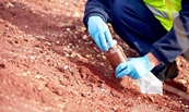 EPA officer gathering a sample of soil.